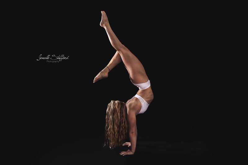 Circus artist and gymnast, Rachael Armstrong, displaying her flexibility and handstand prowess during a studio photoshoot on the Gold Coast.